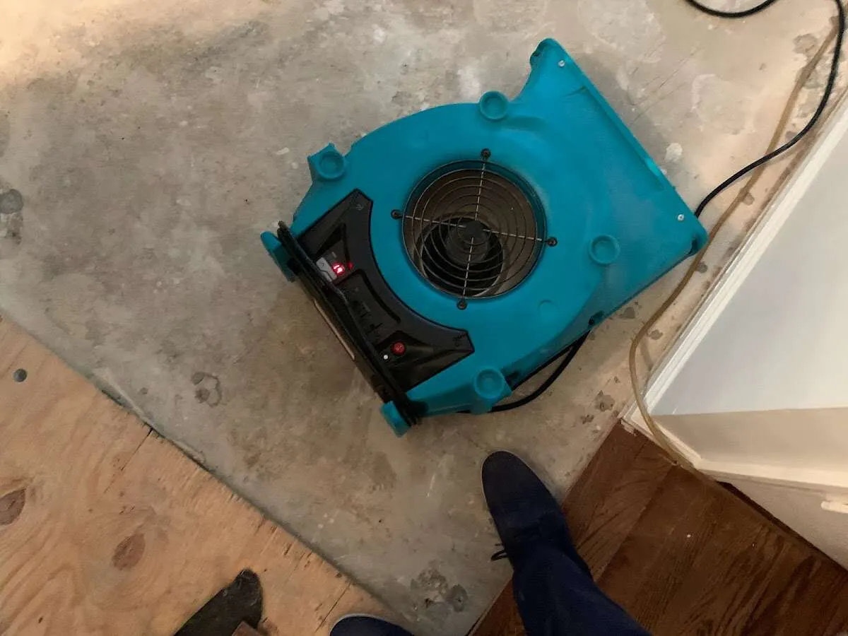 Air mover drying subfloor during Commercial Water Damage Restoration in Glassmanor